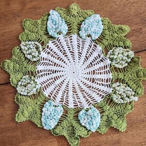 Green and White Crochet Doily with Floral Accents